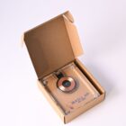 A small gadget in an open brown box labeled SKILL UP with a copper coil visible.