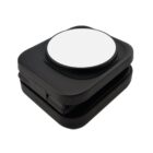 A black, square-shaped device with a round white top, possibly a compact charger.
