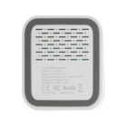 Square white wireless charger with vent holes and technical information printed on the surface.