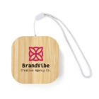 Square bamboo keychain with BrandVibe Creative Agency Co. and a pink abstract flower logo.