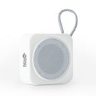 White portable speaker with a circular grill and a braided carrying loop.