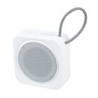 Small white portable speaker with a mesh front and a braided carrying loop.