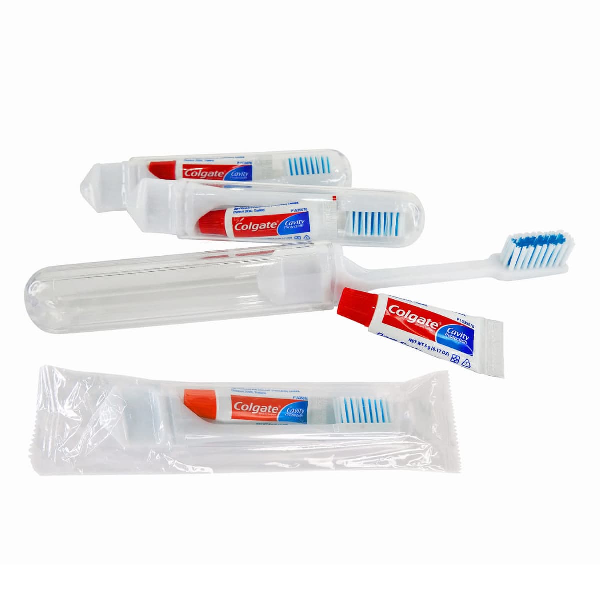 Colgate travel toothbrushes and toothpaste in clear plastic cases and packaging.