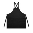 Black apron with cross-back straps and front pockets, displayed on a white background.