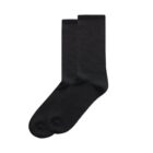 A pair of plain black crew socks on a white background.