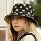 Young girl in Aero Reversible Bucket Hat, looking sideways with long blonde hair.