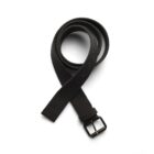 A black fabric belt with a metal buckle rolled up on a white background.