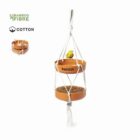 Two-tier hanging bird feeder with a yellow bird, made of bamboo fiber and cotton rope.