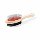 Double-sided grooming brush with a wooden handle, metal bristles, and black bristles.