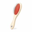A wooden hairbrush with metal bristles and a red cushion on a white background.
