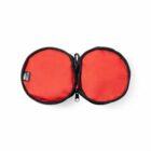 Red, round zippered pouch opened flat with black trim and a small tag on the left side.