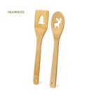 Two bamboo utensils, one with a tree cutout, one with a reindeer cutout, on a white background.