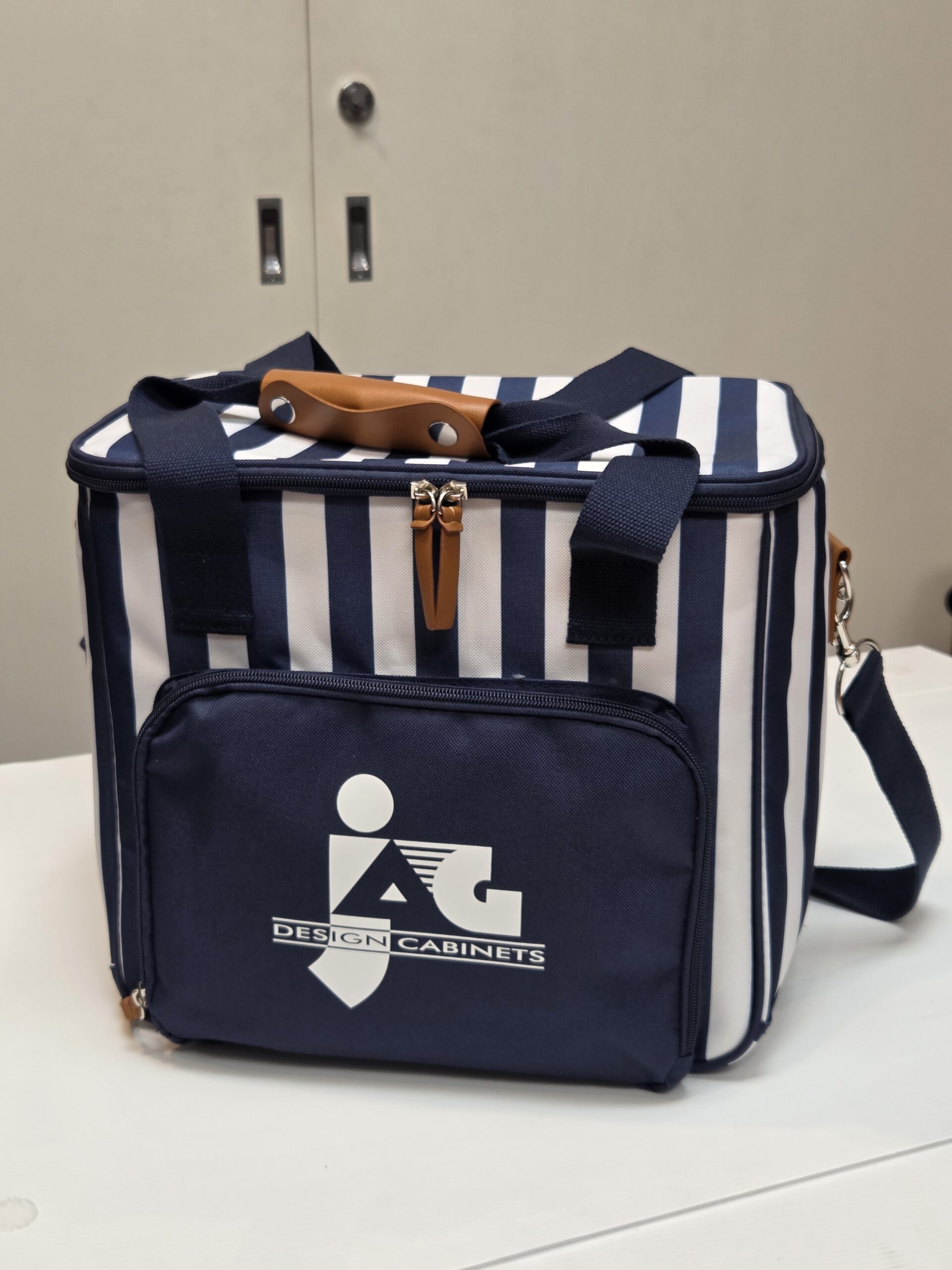 stripes blue and white cooler bag on top of a white surface