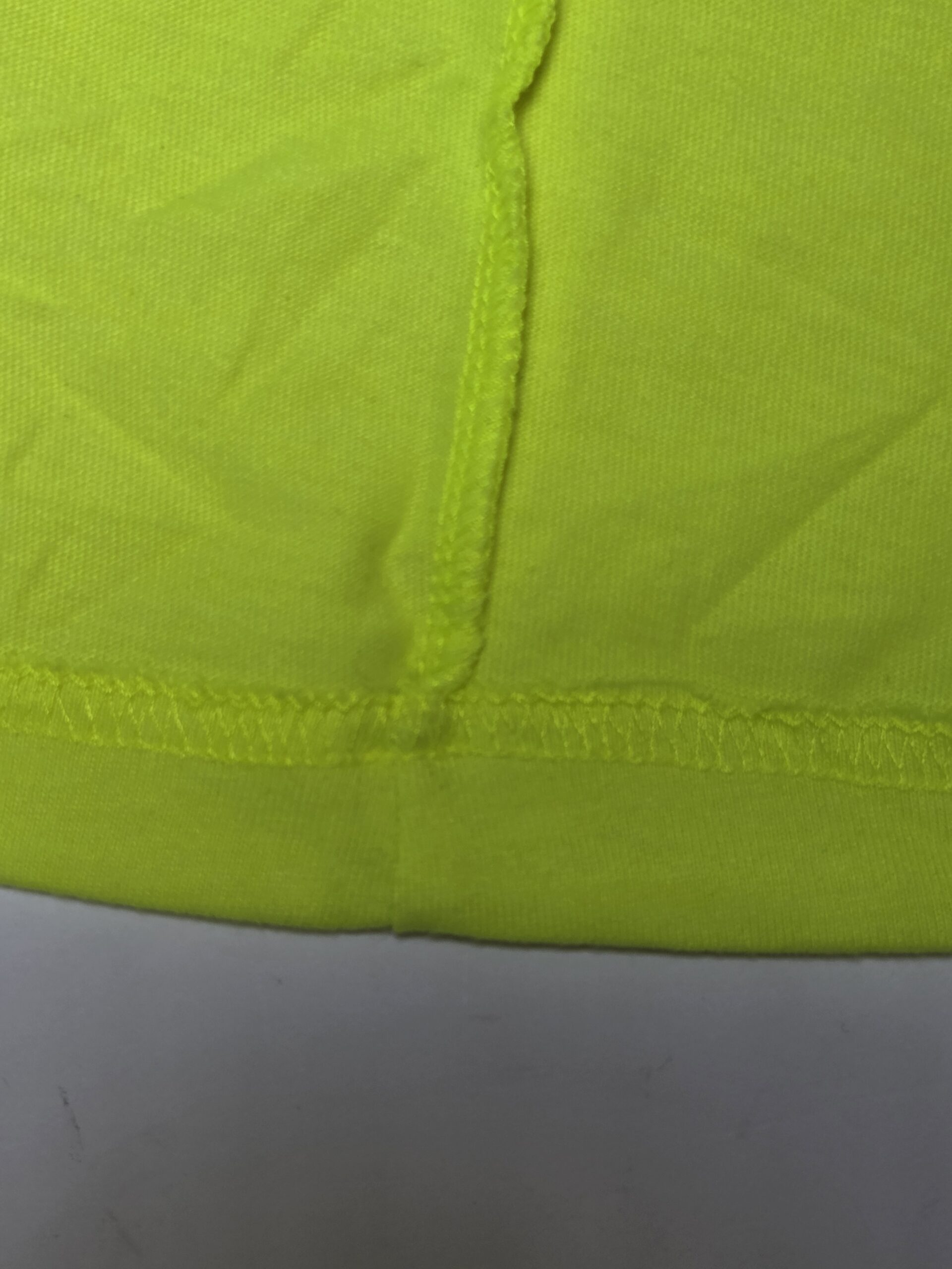 etailed view of neat inside seam stitching on a neon green tee
