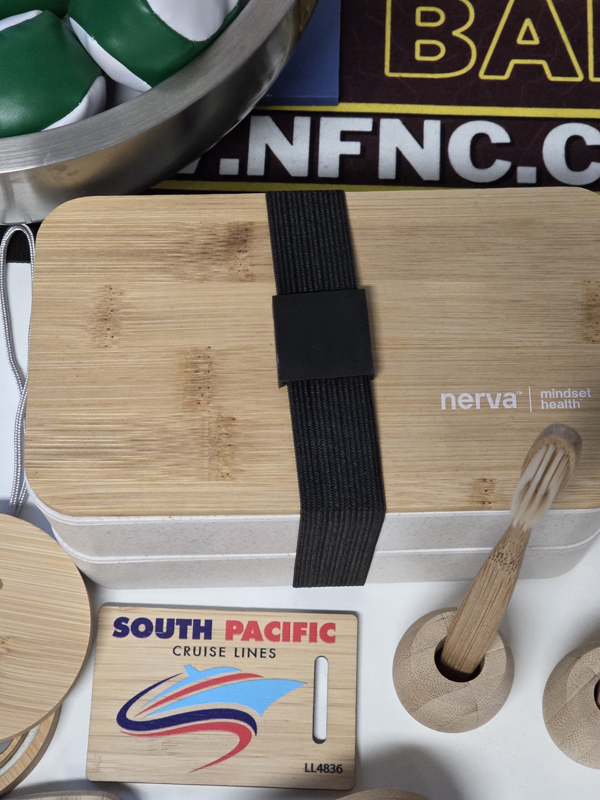 A bamboo lunchbox labeled nerva with bamboo utensils by a South Pacific Cruise Lines tag.