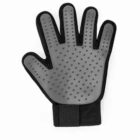 Black pet grooming glove with rubber bristles on the palm side, fingers spread.