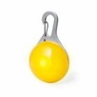 Yellow round LED clip-on safety light with a metal hook against a white background.