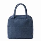 Dark blue fabric lunch bag with two handles, front pocket, and zipper closure.