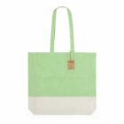 Green and white tote bag with handles and a small brown tag attached.