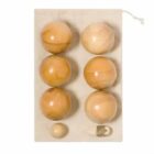 Six wooden balls, a small ball, and a wooden piece with string on a white cloth mat.