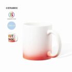 White ceramic mug with a red ombre base and partial AUTUMN text visible on the side.