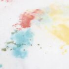 Blue, red, and yellow watercolor stains on a white surface.