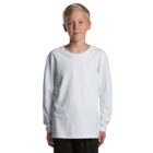 Boy with blond hair wearing a plain white long-sleeve shirt and black pants, facing forward.