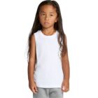Young child with long hair wearing a white sleeveless shirt and gray pants, looking forward.