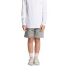 Child in a white long-sleeve shirt, gray shorts, socks, and sneakers standing against white background.