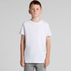 Boy with short hair wearing a plain white t-shirt and gray pants, standing against gray background.