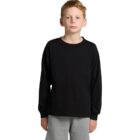 Young boy in a black long-sleeve shirt and gray pants standing against a white background.