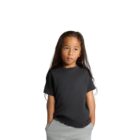Child with long hair wearing a black t-shirt and gray pants, hands in pockets, on white background.