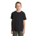 A boy in a black t-shirt and green pants stands against a white background.