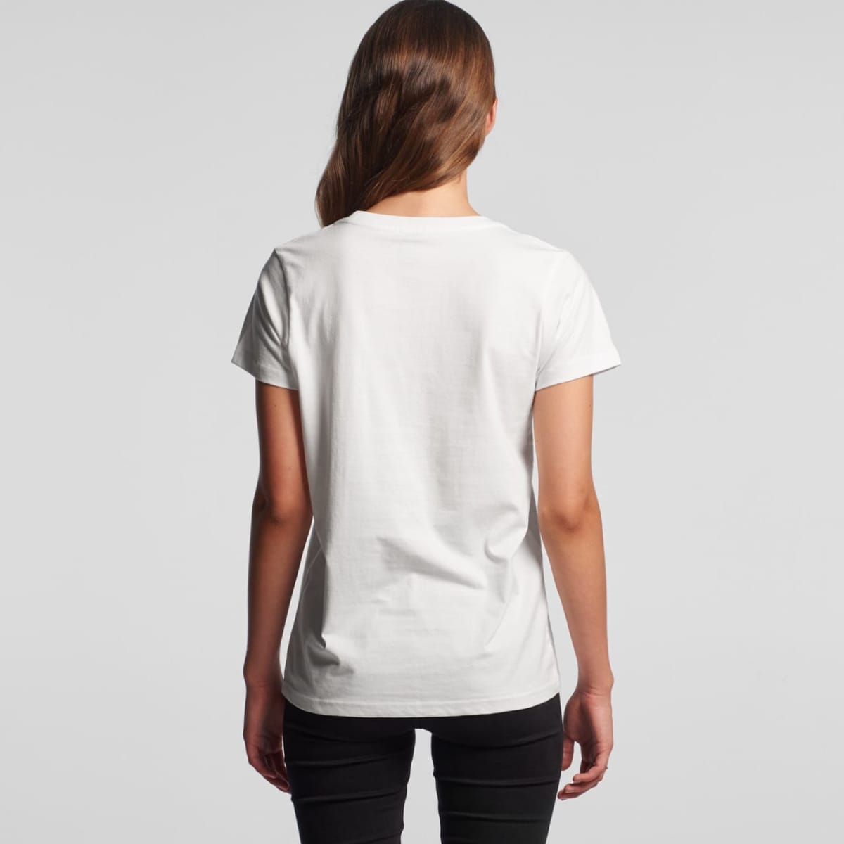 Woman with long brown hair wearing a white t-shirt and black pants, seen from the back.