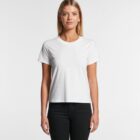 Woman standing in a plain white t-shirt and black pants against a white background.