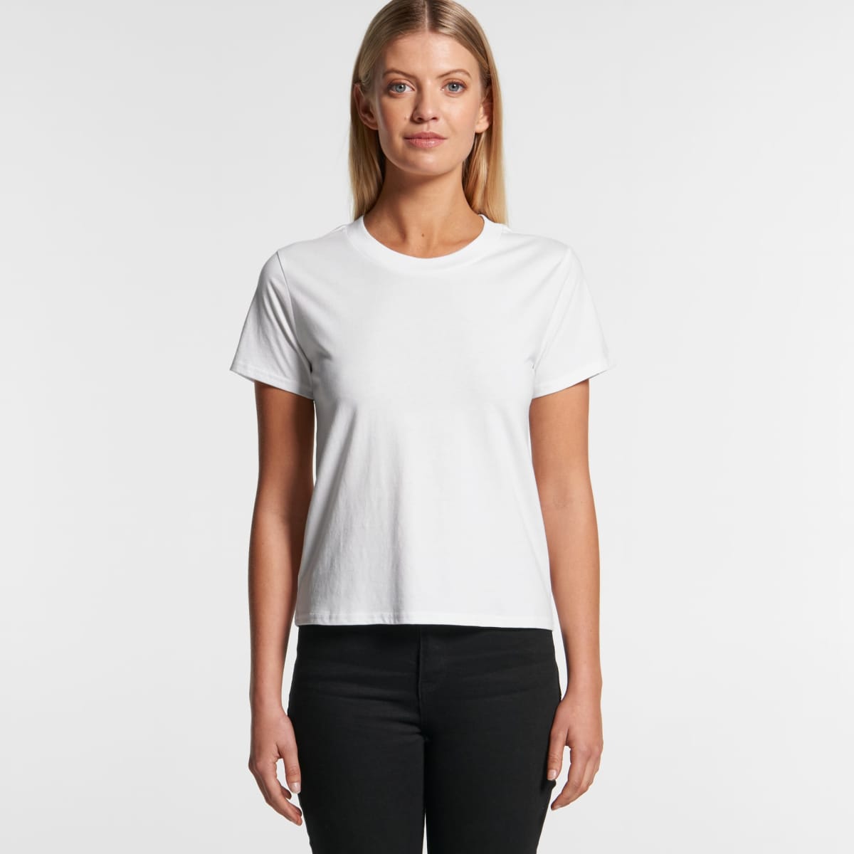 Woman standing in a plain white t-shirt and black pants against a white background.