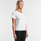 Woman in a plain white t-shirt and black pants standing against a white background.