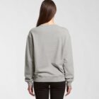 Woman with long brown hair wearing a gray sweatshirt and black pants, seen from the back.