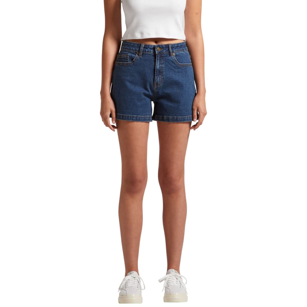 Person wearing blue denim shorts, white crop top, and white sneakers, facing forward.