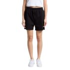 Person wearing a white shirt, black shorts, and white sneakers, standing against a white background.