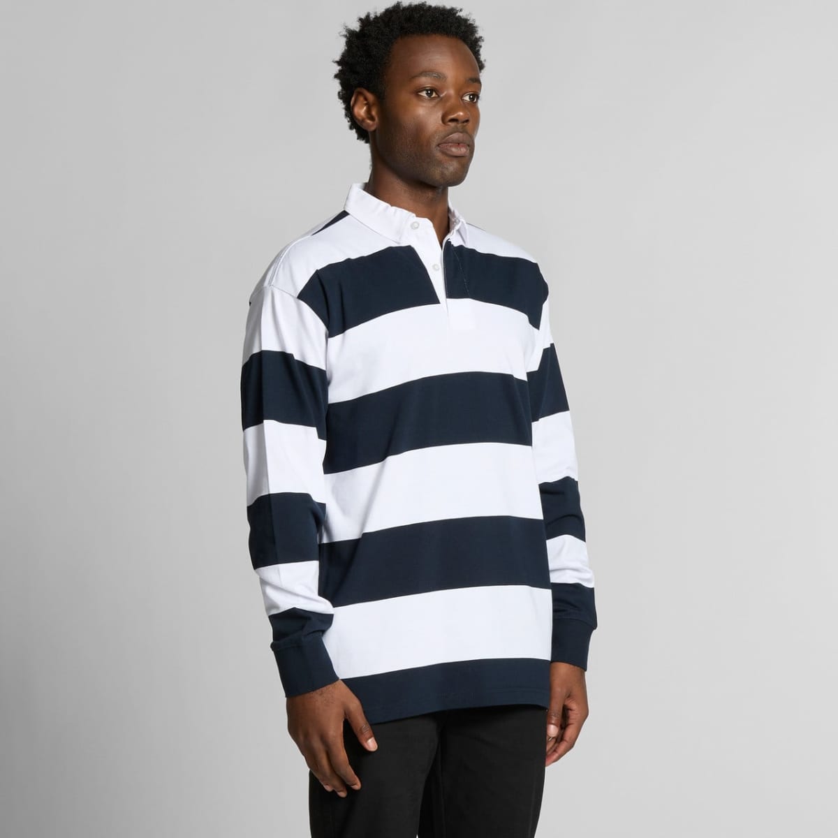 Person wearing a navy and white striped long-sleeve polo shirt against a plain background.