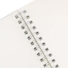 Close-up of an open Everly A5 Full Colour Wiro Binding NoteBook with blank white pages.