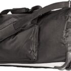 Black duffel bag with wheels and carrying straps, viewed from the side.