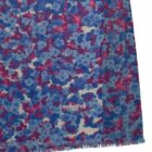 Blue and red floral-patterned fabric with frayed edges and a Cacharel logo.
