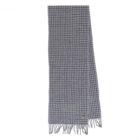 Gray houndstooth patterned scarf with fringed edges, laid flat on a white background.