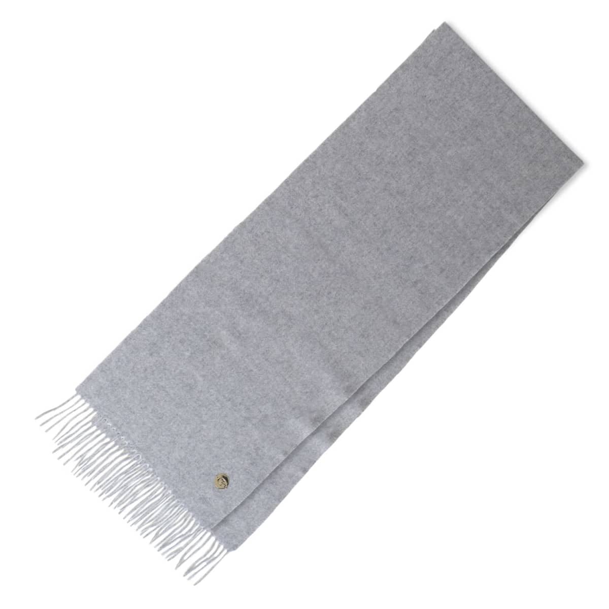 Light gray wool scarf with fringe on one end, laid flat against a white background.
