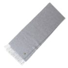 Light gray scarf with fringed ends, neatly folded, and a small round button detail.