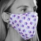 Person wearing a white face mask with purple and blue flower patterns, seen in profile.