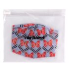 A blue face mask with red butterfly pattern in a clear plastic pouch labeled cacharel.