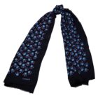 A black scarf with blue and purple floral patterns, knotted at the top.